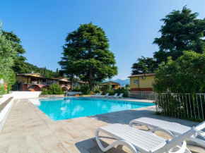 Apartment on Lake Garda with pebble beach pier for boat three swimming pools Raffa